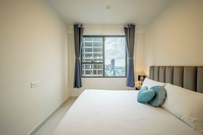 Deluxe Apartment, 2 Bedrooms, City View | Desk, laptop workspace, blackout drapes, iron/ironing board