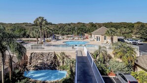 A resort with a large pool, a smaller pool, and a waterfall.