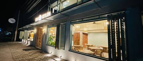 A modern building with a restaurant named "Ceylon" at night.