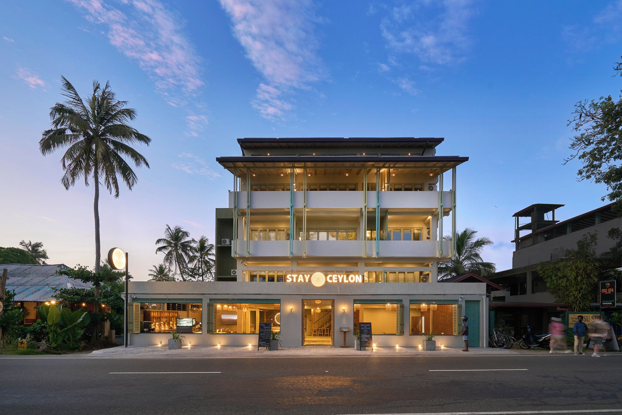 A multi-story hotel with a sign reading "STAY Ceylon".