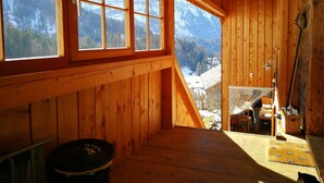 A wooden cabin with large windows, a sloped ceiling, and a view of snow-covered mountains. - Holiday Home 'Ferienhaus-Bregenzerwald' with Mountain View, Private Terrace and Wi-Fi (Bizau)