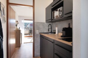 Fridge, microwave, stovetop, coffee/tea maker