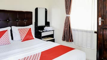 A hotel room with a bed, a nightstand, a mirror, a window with curtains, and a door.