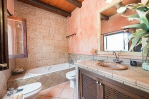A bathroom with a bathtub, two toilets, a sink, and a mirror. - Casa Angela - Villa With Private Pool In Capdepera (Capdepera, Illes Balears)