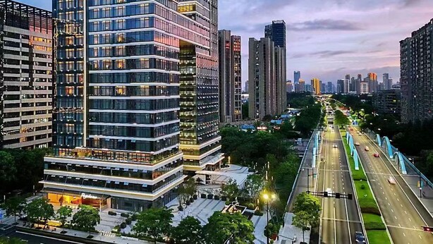 A modern urban area with high-rise buildings, a well-maintained road, and a pedestrian walkway. - Pagoda Hotel Hangzhou Binjiang (Hangzhou)