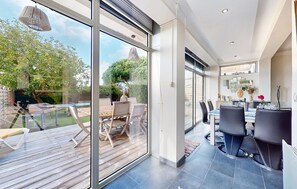 A modern interior with a dining area, a bar, and a view of the outdoors. - Awesome home in Saint-Pierre-d'Oléron with WiFi (Saint-Pierre-d'Oléron)