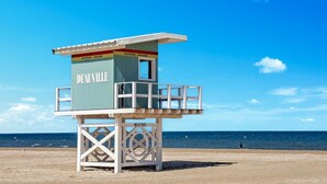 A lifeguard tower labeled 'DEAUVILLE' on a beach with clear skies and calm sea. - Pet friendly home in Fourches with sauna (Fourches)
