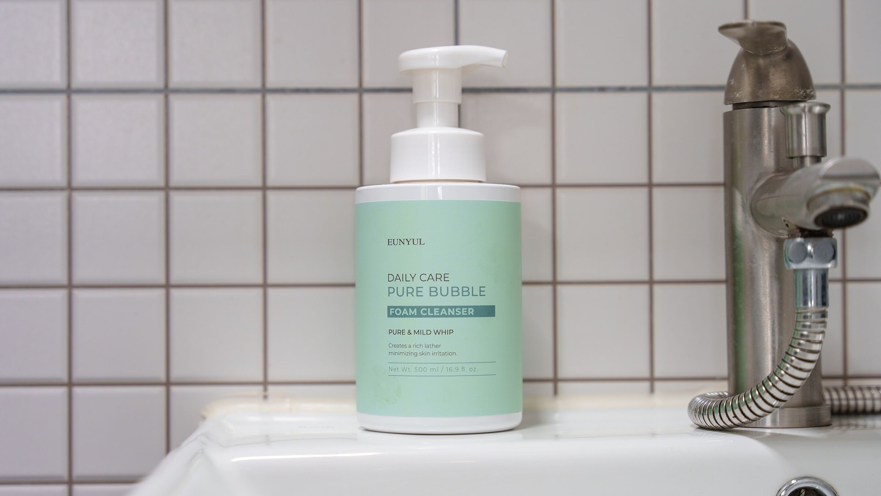 A bathroom sink with a bottle of EUNYUL Daily Care Pure Bubble Foam Cleanser and a faucet.