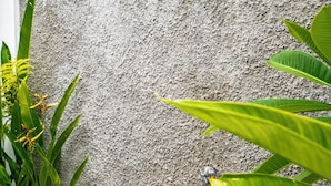 A concrete wall with a built-in showerhead. - Aruna Villa 2 by Betterplace (Canggu)