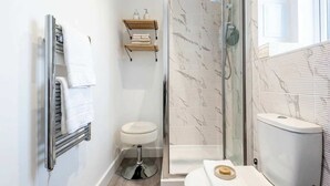 A bathroom with a glass-enclosed shower, a toilet, a towel rack, and a soap dish. - Bright & Spacious 1 Bedroom Apartment in Bradford (Bradford)