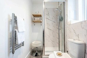 Shower, hair dryer, towels, shampoo
