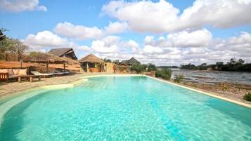 Outdoor pool, pool umbrellas, lifeguards on site