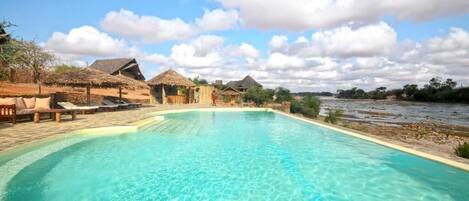 Outdoor pool, pool umbrellas, lifeguards on site