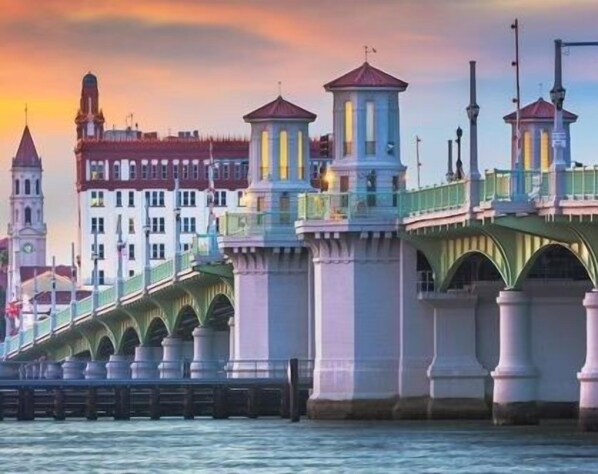 A bridge with multiple arches and a tower.