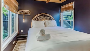 A bedroom with a bed, a ceiling fan, and a window with blinds. - Welcome to your ultimate holiday getaway! (Tweed)