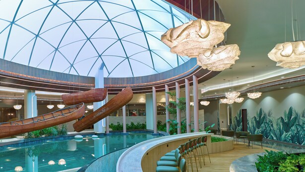 A spacious indoor area with a large pool, seating areas, and a high ceiling with a geometric glass design. - 0484 Aero Lounge - Terminal 2, Cochin Airport Hotel (Aluva)