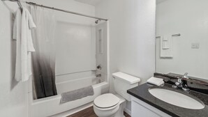 Un baño moderno con bañera, inodoro y lavamanos.
