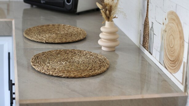 A kitchen with a white countertop, a toaster, and decorative wall art. - Room in Chalet - Amlou Surf House - Villa (Mirissa)