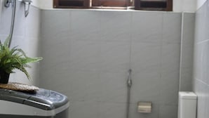 A compact bathroom with a toilet, a shower, and a sink. - Room in Chalet - Amlou Surf House-villa (Mirissa)
