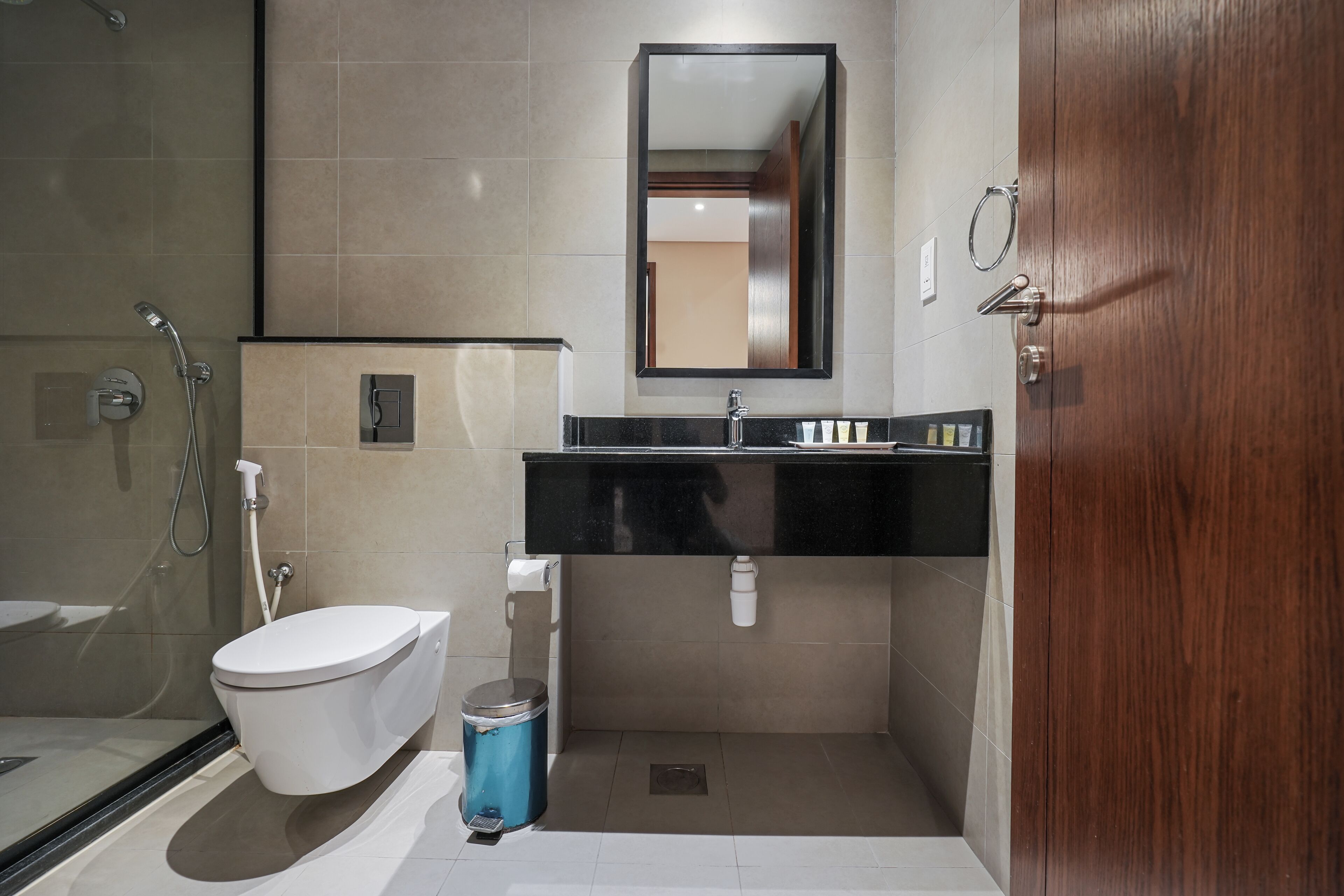 A modern bathroom with a toilet, sink, and shower.