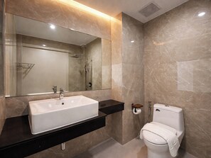 A modern bathroom with a large mirror, a white sink, a toilet, and a shower area. - View khong Hotel (Chiang Saen)
