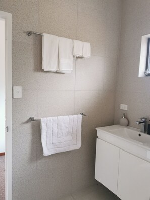 Habitación doble familiar | Baño | Regadera, toallas, jabón, shampoo 