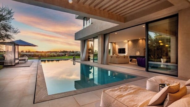 A modern house with a swimming pool, outdoor seating, and a large glass window. - Villa Blanchette  (Marrakech)