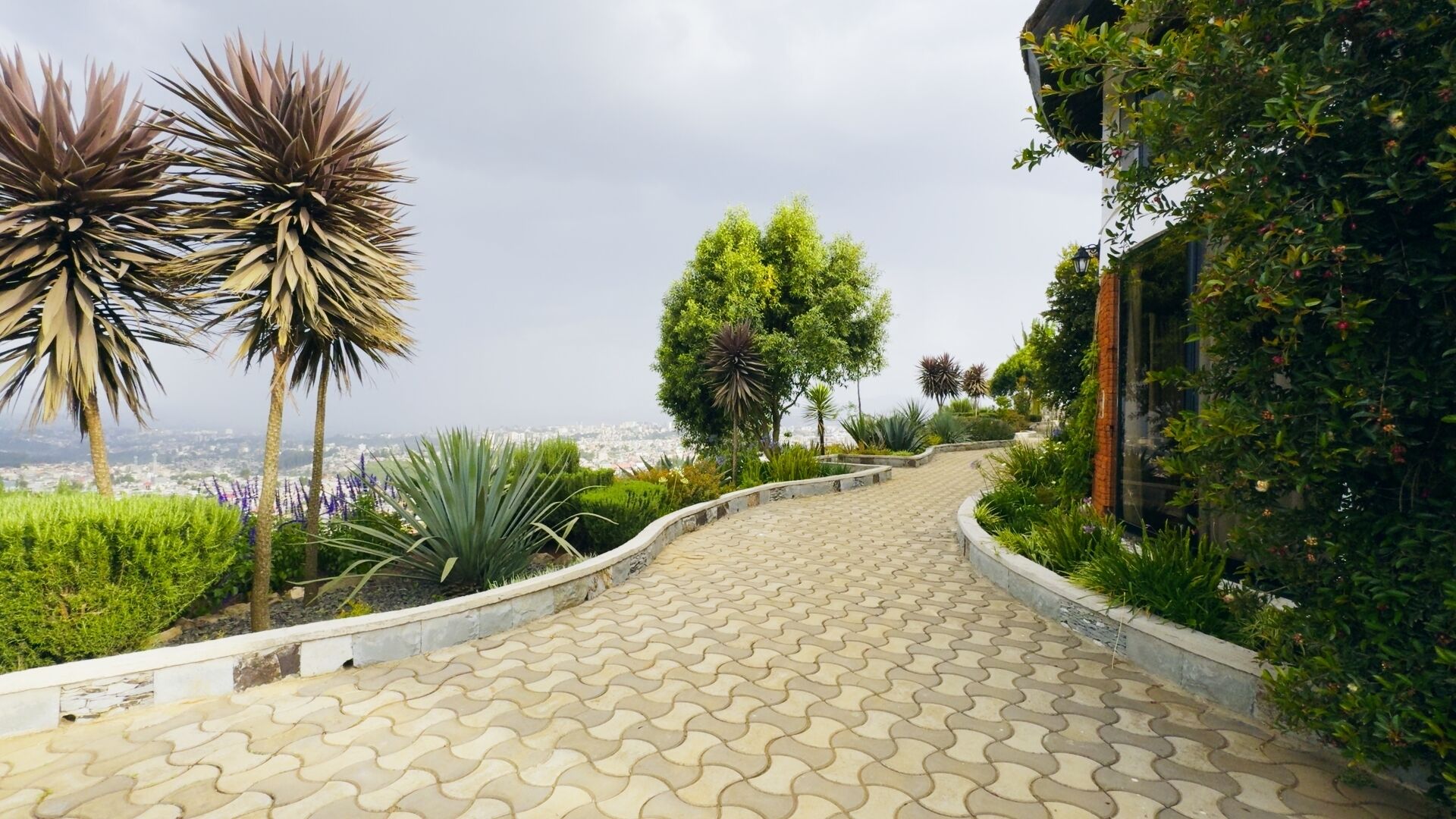 A paved pathway with a view of a cityscape.
