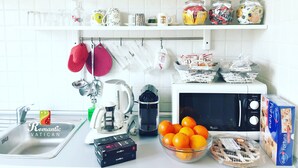 A kitchen with white cabinets, a microwave, a toaster, and a sink. - Cozy house with balcony for couples 5 minutes from St. Peter's Basilica (Roma)