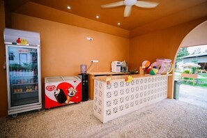 A room with a ceiling fan, a refrigerator, a coffee machine, and a counter with colorful balls. - Lilla Rainforest Retreat @ Hulu Langat (Hulu Langat)