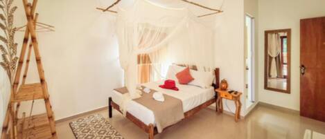 A room with a bed, a bedside table, a wooden ladder, and a patterned rug.