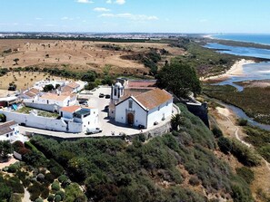 An aerial view of a coastal village with white buildings, a church, and a beach. - Aris Apartment, Vila Nova de Cacela, Algarve (Vila Nova de Cacela)