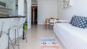 A compact, modern room with a kitchenette, a dining area, and a bed. - Aris Apartment, Vila Nova de Cacela, Algarve (Vila Nova de Cacela)