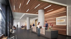 A modern hotel lobby with a reception desk, seating areas, and a wooden ceiling.