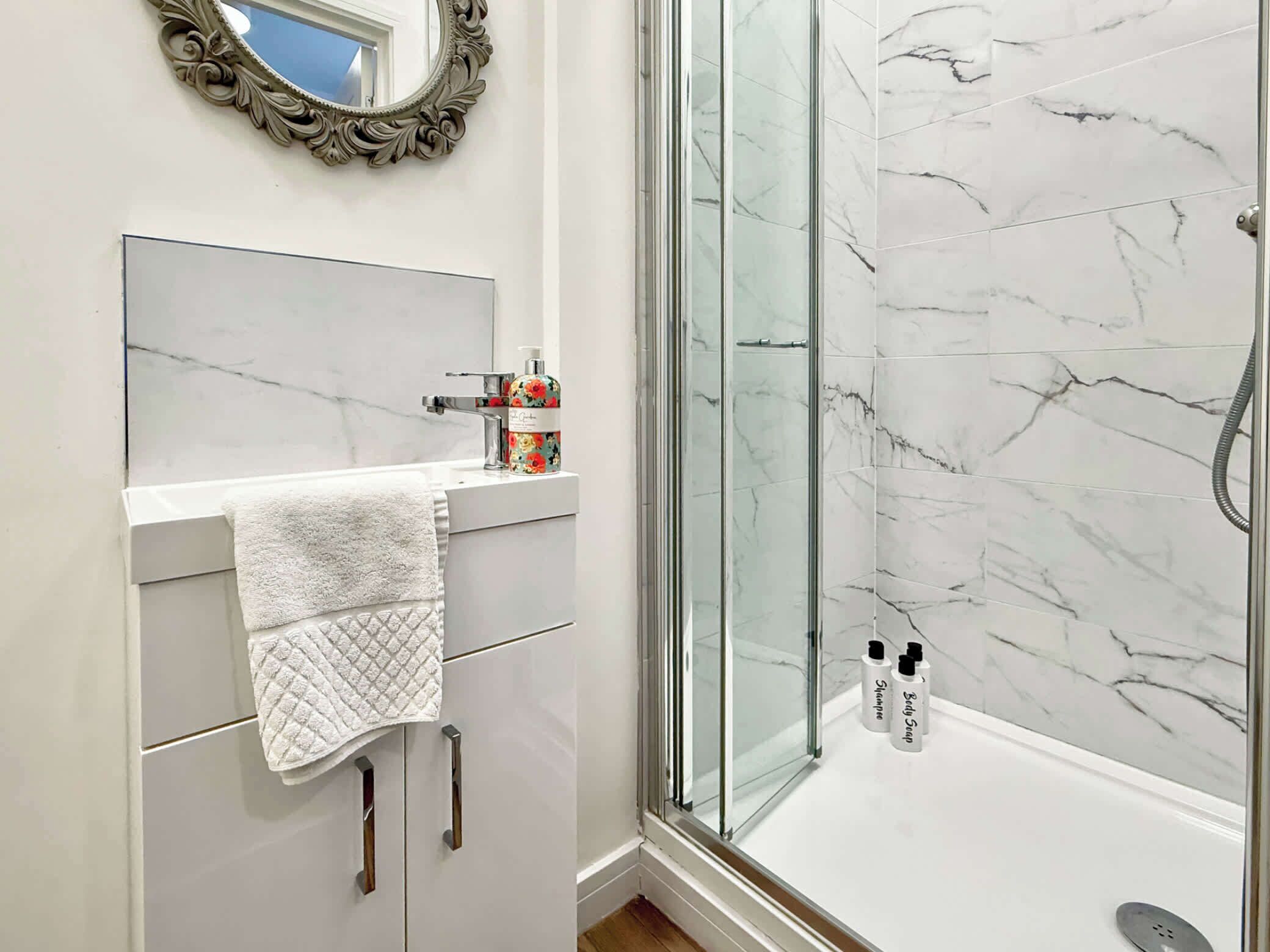 Shower, hair dryer, towels, shampoo