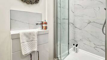 Shower, hair dryer, towels, shampoo