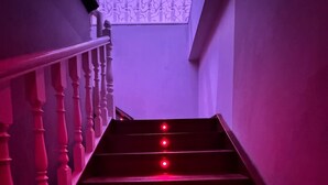 A staircase with red lighting, a patterned wall, and a view of the sky. - dubai resort (Ponteareas)