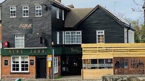 A two-story building with a sign for 'The Suffolk Hotel' and 'Nine Jars' below. - The Suffolk Hotel (Haverhill)