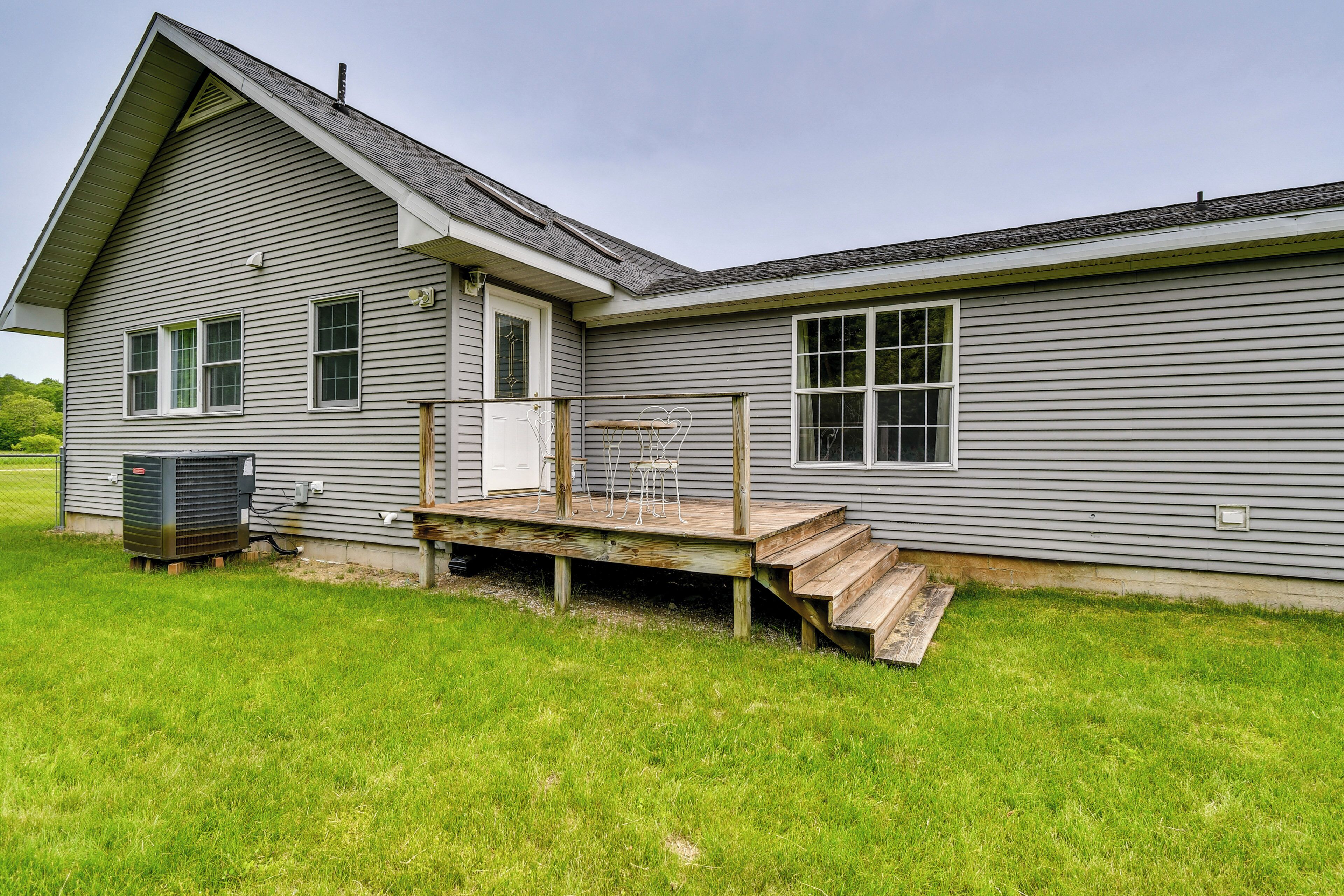 A single-story house with a covered porch and a small deck.