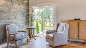 A room with two armchairs, a small round table, and a cabinet. - Hope Retreat w/ Furnished Deck Near Parks! (Hope)