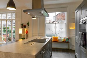 Enjoy cooking in this well-equipped kitchen with a central island, stovetop, and range hood.