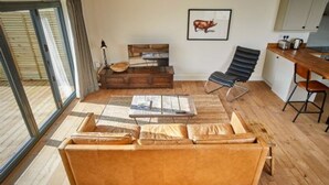A cozy living room with a sofa, coffee table, and a framed picture on the wall. - Host Stay Number Two Piglets (King's Lynn)