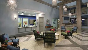 A spacious lobby with a reception desk, multiple seating areas, and decorative lighting. - Wonderfull 4Bd w Pool Champions Gate Resort 8945 (Davenport)