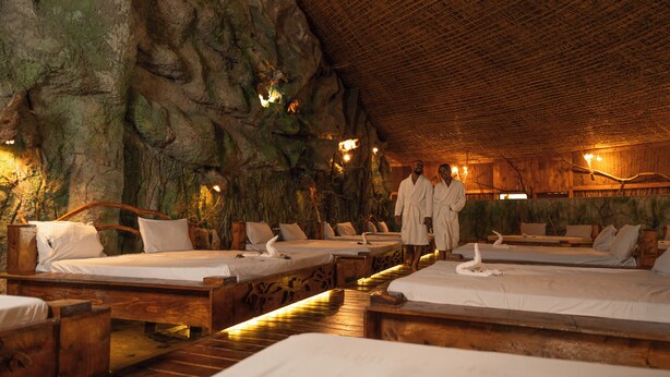 A cave-like room with wooden beds and a rustic ceiling. - Kuriftu Entoto Adventure Park (Addis Ababa)