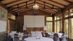 A conference room with round tables and chairs, whiteboards, and a projector screen. - Kuriftu Entoto Adventure Park (Addis Ababa)