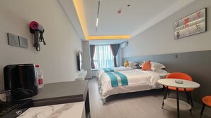 A hotel room with two beds, a desk, a chair, a small table, a TV, and a window with curtains. - Qin Mengli Hotel (Xianyang)