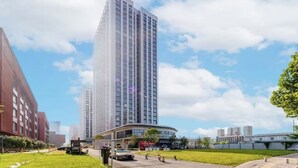 A modern high-rise building with a curved entrance and a parking area in front. - Qin Mengli Hotel (Xianyang)