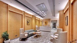 A modern lobby with a reception desk, seating area, and a marble floor. - Click collection Lucknow (Lucknow)