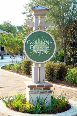 Welcome to Coligny Beach Park, where a beautiful sign marks the entrance to a serene landscaped area.