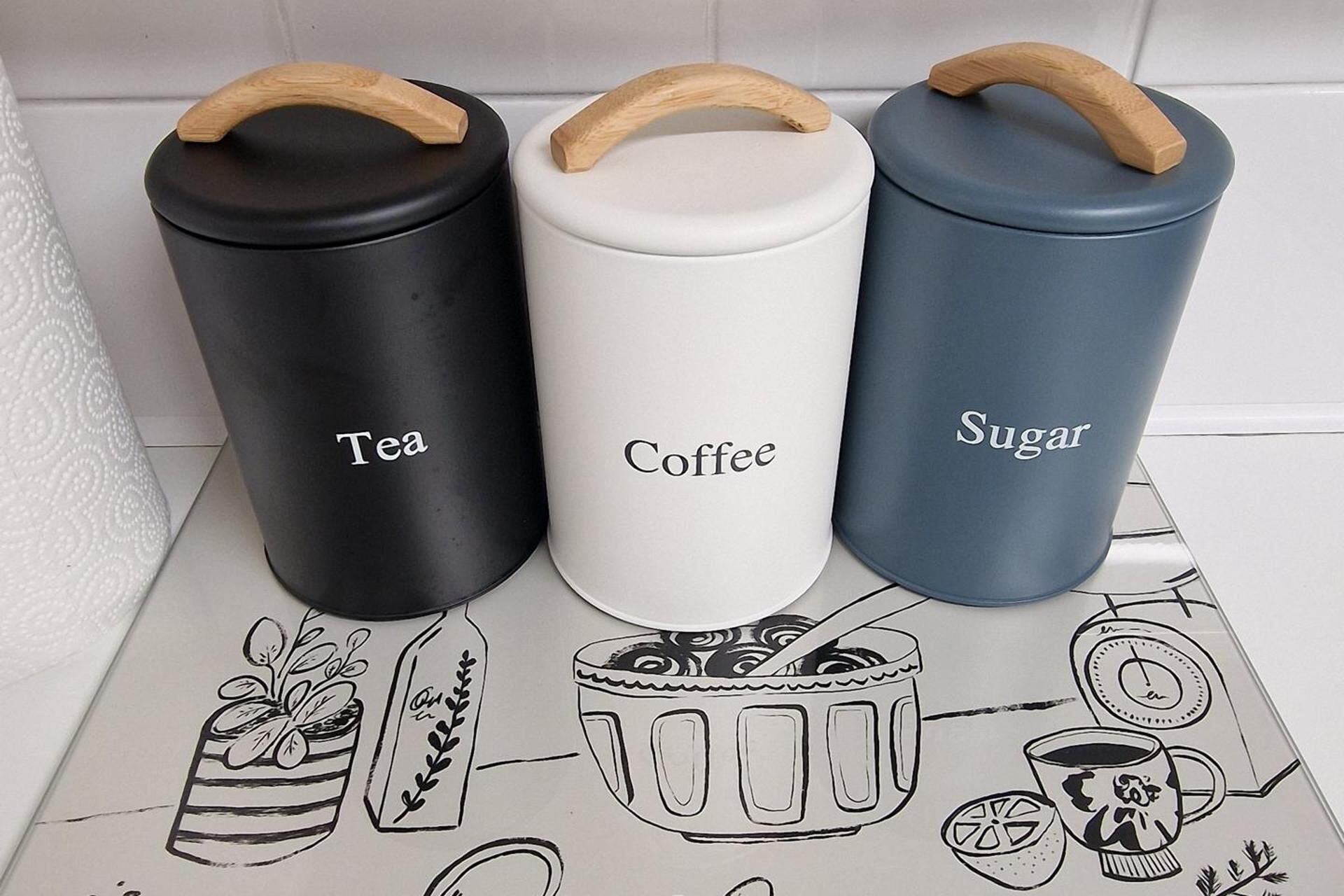 Three containers labeled Tea, Coffee, and Sugar.